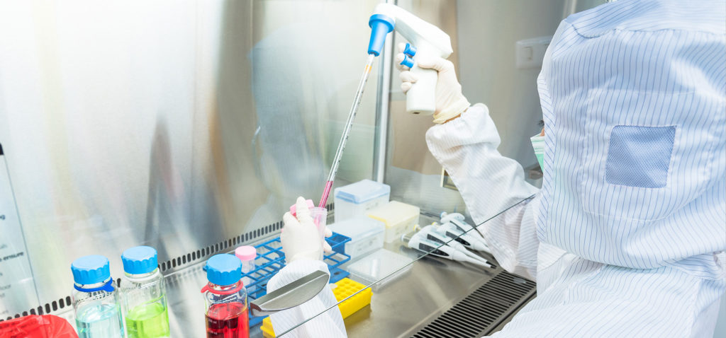 Worker in Sterile Gown Performaing Sampling and Handling for Client Products