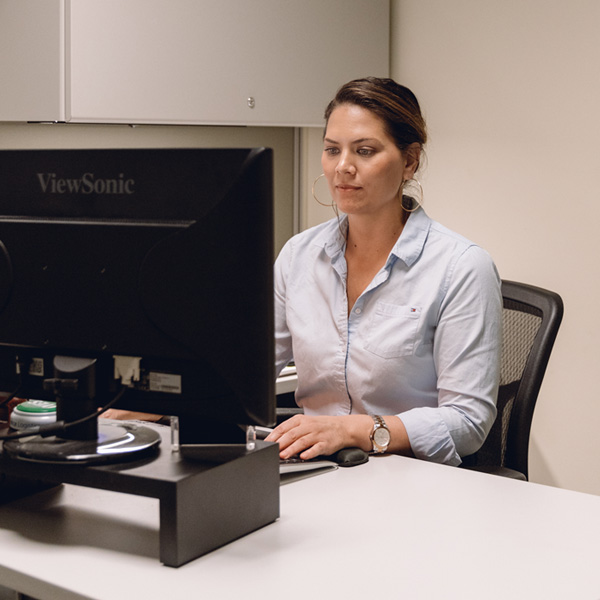 Female Staff In Front of Monitor Handling Order to Cash Distribution Support for Clients