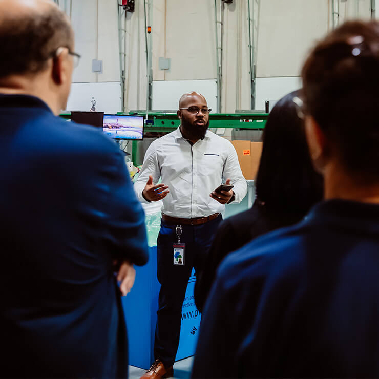 Male Team Leader Speaking and Encouraging LSL Staff Employees